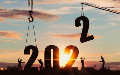 silhuetas de trabalhadores e grua a construir o número 2022, imagem ilustrativa do artigo “Previsões para 2022 no setor logístico”